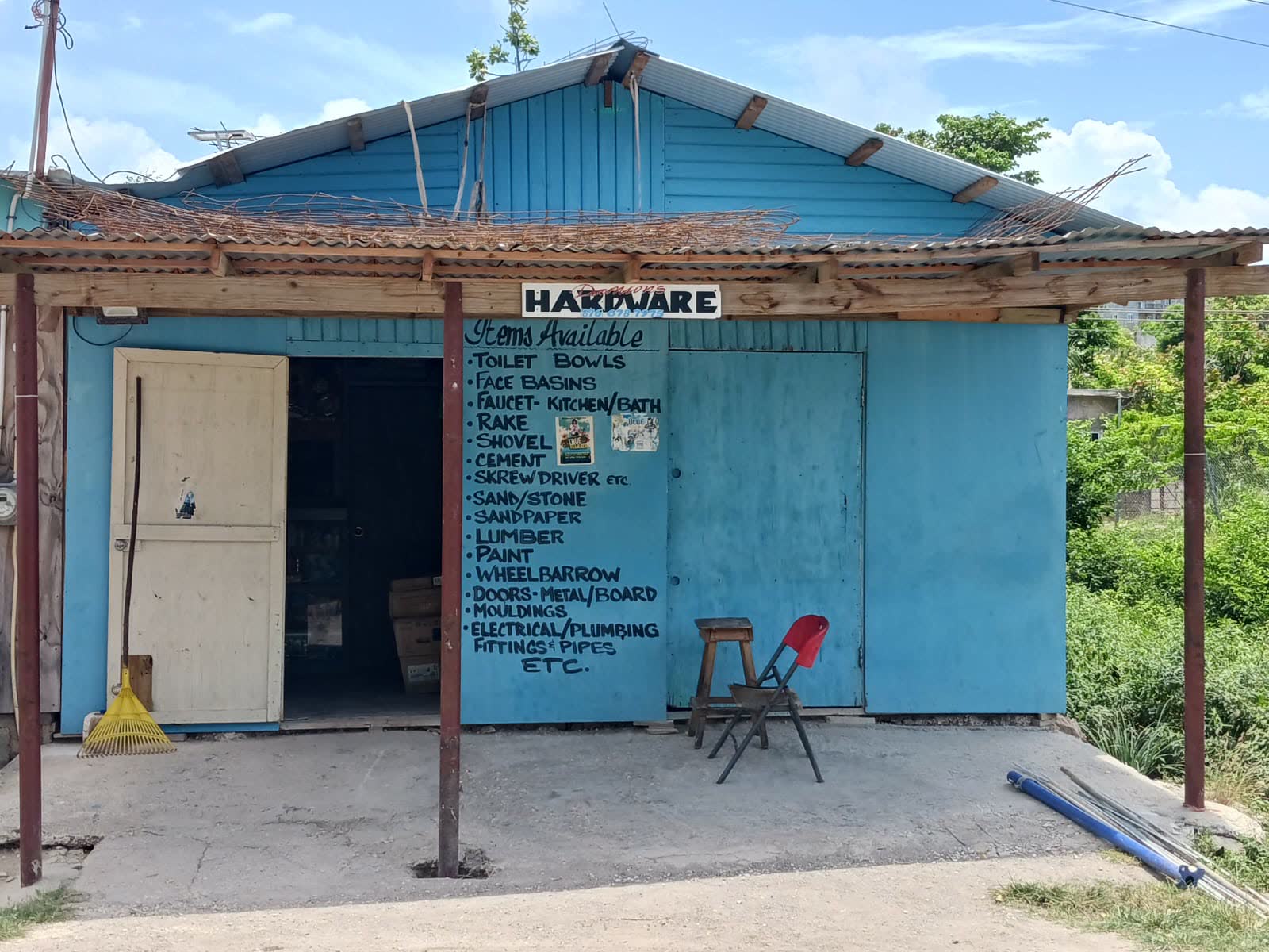 Damian Hardware shopfront in Long Bay with the painted items list